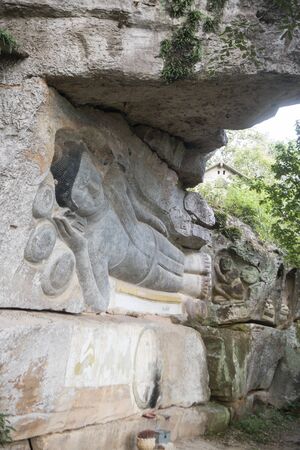 a carved sandstone Buddha Image at the Phnom Santuk Temple near of the city of Kampong Thom of Cambodia.  Cambodia, Kampong Thom, November, 2017,のeditorial素材