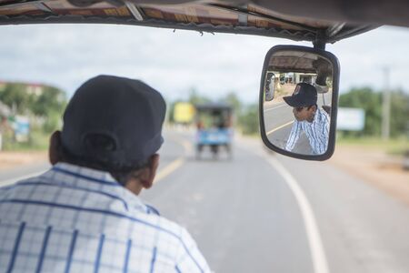 a tuk tuk at the mainroad in the city centre of Kampong Thom of Cambodia.  Cambodia, Kampong Thom, November, 2017,のeditorial素材