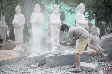 a Buddha carving factory at the Village of Kakaoh east of the city of Kampong Thom of Cambodia.  Cambodia, Kampong Thom, November, 2017,のeditorial素材