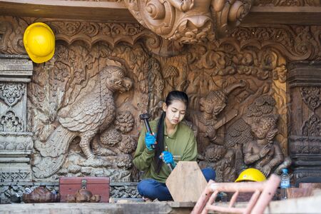 workers from Myanmar on wood carving work for the Wood Sanctuary of Truth Temple in the city of Pattaya in the Provinz Chonburi in Thailand.  Thailand, Pattaya, November, 2018のeditorial素材