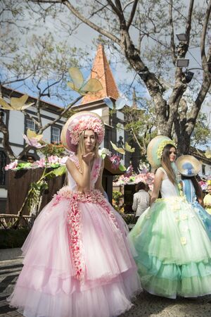 women dressed in colorful clothes at the Festa da Flor or Spring Flower Festival in the city of Funchal on the Island of Madeira in the Atlantic Ocean of Portugal.  Madeira, Funchal, April, 2018のeditorial素材