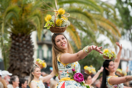 women dressed in colorful clothes at the Festa da Flor or Spring Flower Festival in the city of Funchal on the Island of Madeira in the Atlantic Ocean of Portugal.  Madeira, Funchal, April, 2018のeditorial素材