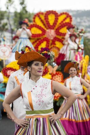 women dressed in colorful clothes at the Festa da Flor or Spring Flower Festival in the city of Funchal on the Island of Madeira in the Atlantic Ocean of Portugal.  Madeira, Funchal, April, 2018のeditorial素材