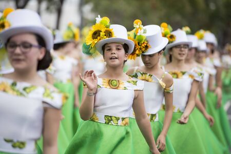 women dressed in colorful clothes at the Festa da Flor or Spring Flower Festival in the city of Funchal on the Island of Madeira in the Atlantic Ocean of Portugal.  Madeira, Funchal, April, 2018のeditorial素材