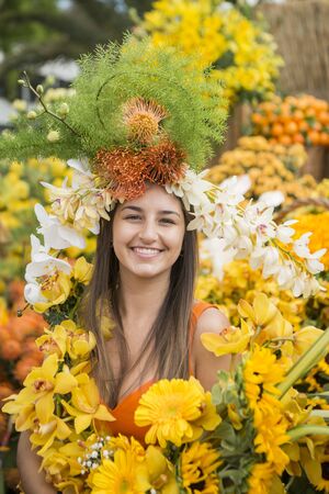 women dressed in colorful clothes at the Festa da Flor or Spring Flower Festival in the city of Funchal on the Island of Madeira in the Atlantic Ocean of Portugal.  Madeira, Funchal, April, 2018のeditorial素材