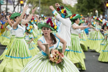 women dressed in colorful clothes at the Festa da Flor or Spring Flower Festival in the city of Funchal on the Island of Madeira in the Atlantic Ocean of Portugal.  Madeira, Funchal, April, 2018のeditorial素材
