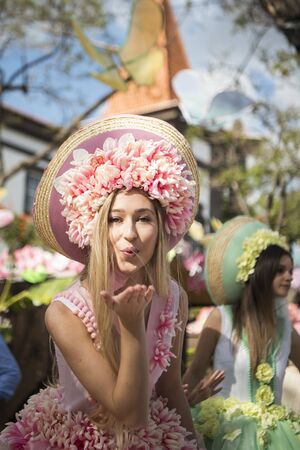 women dressed in colorful clothes at the Festa da Flor or Spring Flower Festival in the city of Funchal on the Island of Madeira in the Atlantic Ocean of Portugal.  Madeira, Funchal, April, 2018のeditorial素材