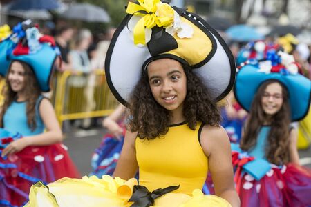 women dressed in colorful clothes at the Festa da Flor or Spring Flower Festival in the city of Funchal on the Island of Madeira in the Atlantic Ocean of Portugal.  Madeira, Funchal, April, 2018のeditorial素材