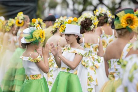 women dressed in colorful clothes at the Festa da Flor or Spring Flower Festival in the city of Funchal on the Island of Madeira in the Atlantic Ocean of Portugal.  Madeira, Funchal, April, 2018のeditorial素材