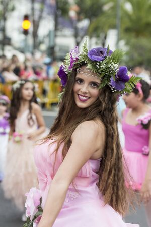 women dressed in colorful clothes at the Festa da Flor or Spring Flower Festival in the city of Funchal on the Island of Madeira in the Atlantic Ocean of Portugal.  Madeira, Funchal, April, 2018のeditorial素材