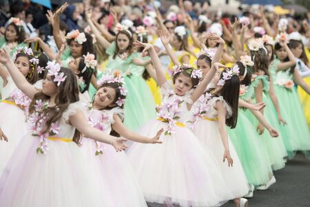 children dressed in colorful clothes at the Festa da Flor or Spring Flower Festival in the city of Funchal on the Island of Madeira in the Atlantic Ocean of Portugal.  Madeira, Funchal, April, 2018のeditorial素材
