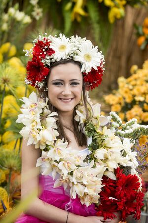 women dressed in colorful clothes at the Festa da Flor or Spring Flower Festival in the city of Funchal on the Island of Madeira in the Atlantic Ocean of Portugal.  Madeira, Funchal, April, 2018のeditorial素材