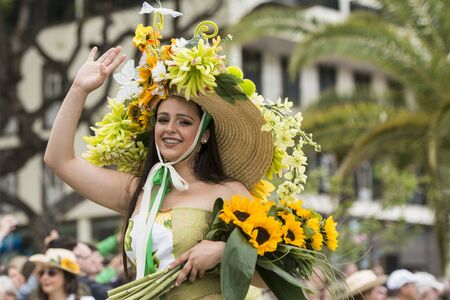 women dressed in colorful clothes at the Festa da Flor or Spring Flower Festival in the city of Funchal on the Island of Madeira in the Atlantic Ocean of Portugal.  Madeira, Funchal, April, 2018のeditorial素材