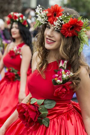women dressed in colorful clothes at the Festa da Flor or Spring Flower Festival in the city of Funchal on the Island of Madeira in the Atlantic Ocean of Portugal.  Madeira, Funchal, April, 2018のeditorial素材