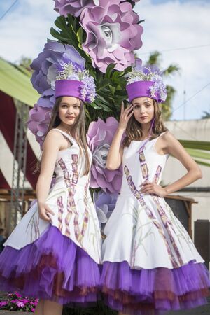 women dressed in colorful clothes at the Festa da Flor or Spring Flower Festival in the city of Funchal on the Island of Madeira in the Atlantic Ocean of Portugal.  Madeira, Funchal, April, 2018のeditorial素材