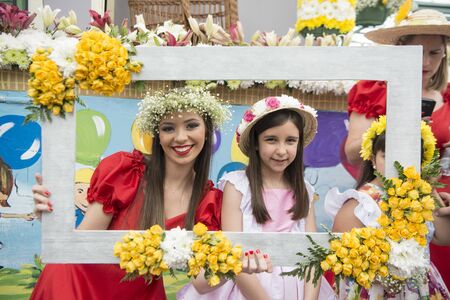 children dressed in colorful clothes at the Festa da Flor or Spring Flower Festival in the city of Funchal on the Island of Madeira in the Atlantic Ocean of Portugal.  Madeira, Funchal, April, 2018のeditorial素材