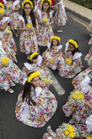 children dressed in colorful clothes at the Festa da Flor or Spring Flower Festival in the city of Funchal on the Island of Madeira in the Atlantic Ocean of Portugal.  Madeira, Funchal, April, 2018のeditorial素材