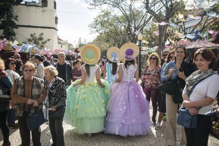 women dressed in colorful clothes at the Festa da Flor or Spring Flower Festival in the city of Funchal on the Island of Madeira in the Atlantic Ocean of Portugal.  Madeira, Funchal, April, 2018のeditorial素材
