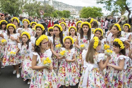 children dressed in colorful clothes at the Festa da Flor or Spring Flower Festival in the city of Funchal on the Island of Madeira in the Atlantic Ocean of Portugal.  Madeira, Funchal, April, 2018のeditorial素材