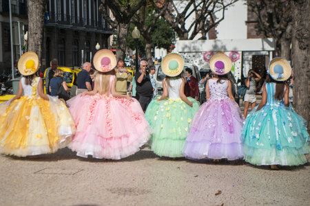 women dressed in colorful clothes at the Festa da Flor or Spring Flower Festival in the city of...