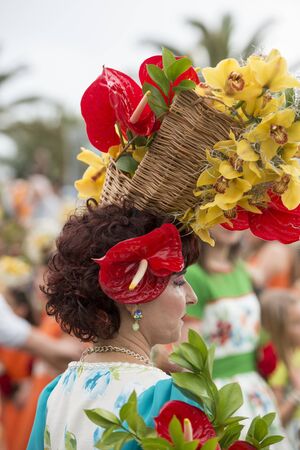 women dressed in colorful clothes at the Festa da Flor or Spring Flower Festival in the city of Funchal on the Island of Madeira in the Atlantic Ocean of Portugal.  Madeira, Funchal, April, 2018のeditorial素材