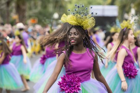 women dressed in colorful clothes at the Festa da Flor or Spring Flower Festival in the city of Funchal on the Island of Madeira in the Atlantic Ocean of Portugal.  Madeira, Funchal, April, 2018のeditorial素材