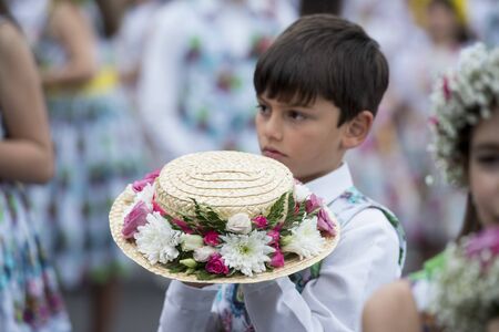 boy dressed in colorful clothes at the Festa da Flor or Spring Flower Festival in the city of Funchal on the Island of Madeira in the Atlantic Ocean of Portugal.  Madeira, Funchal, April, 2018のeditorial素材