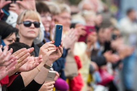 people ta a photo with a smart phone at the Festa da Flor or Spring Flower Festival in the city of Funchal on the Island of Madeira in the Atlantic Ocean of Portugal.  Madeira, Funchal, April, 2018のeditorial素材