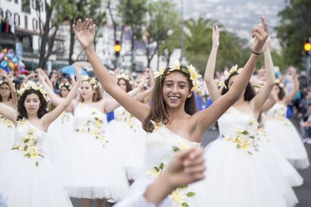 women dressed in colorful clothes at the Festa da Flor or Spring Flower Festival in the city of Funchal on the Island of Madeira in the Atlantic Ocean of Portugal.  Madeira, Funchal, April, 2018のeditorial素材