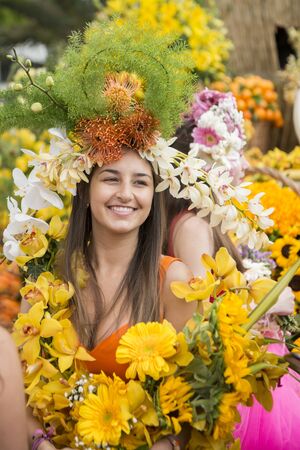 women dressed in colorful clothes at the Festa da Flor or Spring Flower Festival in the city of Funchal on the Island of Madeira in the Atlantic Ocean of Portugal.  Madeira, Funchal, April, 2018のeditorial素材