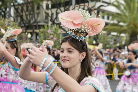 women dressed in colorful clothes at the Festa da Flor or Spring Flower Festival in the city of Funchal on the Island of Madeira in the Atlantic Ocean of Portugal.  Madeira, Funchal, April, 2018のeditorial素材
