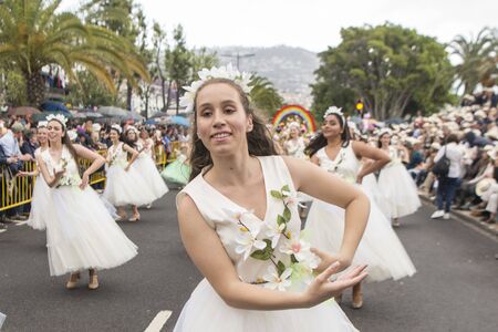 women dressed in colorful clothes at the Festa da Flor or Spring Flower Festival in the city of Funchal on the Island of Madeira in the Atlantic Ocean of Portugal.  Madeira, Funchal, April, 2018のeditorial素材