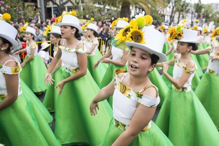 women dressed in colorful clothes at the Festa da Flor or Spring Flower Festival in the city of Funchal on the Island of Madeira in the Atlantic Ocean of Portugal.  Madeira, Funchal, April, 2018のeditorial素材