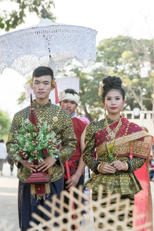 traditional dresst thai people at the Loy Krathong Festival in the Historical Park in Sukhothai in the Provinz Sukhothai in Thailand.   Thailand, Sukhothai, November, 2018のeditorial素材