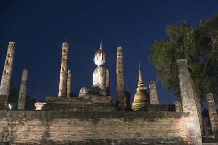 a Buddha with a stupa at the Wat Mahathat Temple at the Historical Park in Sukhothai in the Provinz Sukhothai in Thailand.   Thailand, Sukhothai, November, 2018のeditorial素材