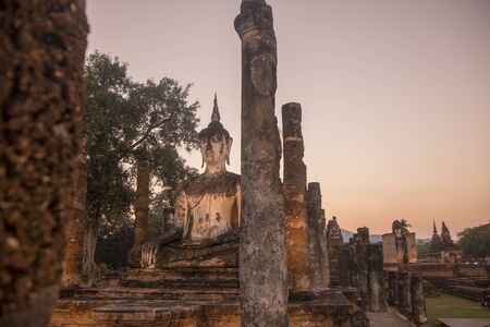 a Buddha with a stupa at the Wat Mahathat Temple at the Historical Park in Sukhothai in the Provinz Sukhothai in Thailand.   Thailand, Sukhothai, November, 2018のeditorial素材