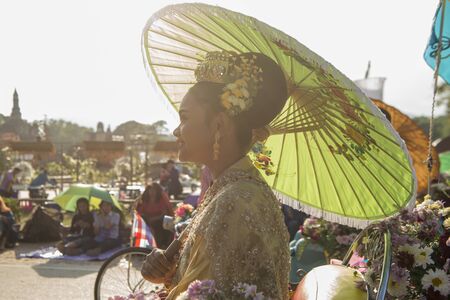 traditional dresst thai people at the Loy Krathong Festival in the Historical Park in Sukhothai in the Provinz Sukhothai in Thailand.   Thailand, Sukhothai, November, 2018のeditorial素材