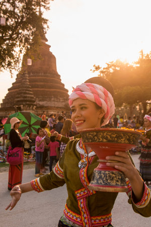 traditional dresst thai people at the Loy Krathong Festival in the Historical Park in Sukhothai in the Provinz Sukhothai in Thailand.   Thailand, Sukhothai, November, 2018のeditorial素材
