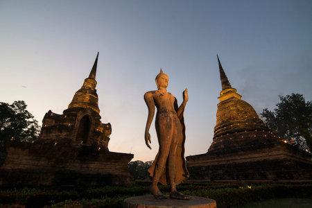 a Buddha with a stupa at the Wat Sa Si Temple at the Historical Park in Sukhothai in the Provinz...