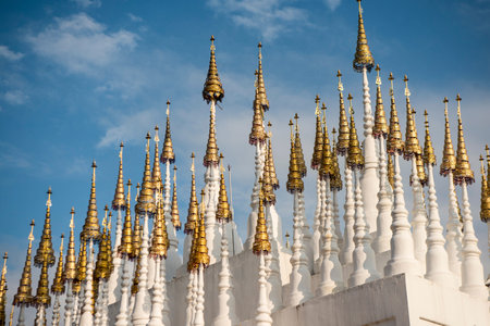 the white and golden Stupas and chedi at a rood of a temple at Wat Pong Sunan Temple in the city of  Phrae in the north of Thailand.  Thailand, Phrae November, 2018.のeditorial素材