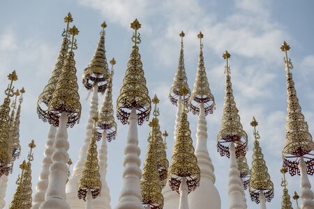 the white and golden Stupas and chedi at a rood of a temple at Wat Pong Sunan Temple in the city of  Phrae in the north of Thailand.  Thailand, Phrae November, 2018.のeditorial素材