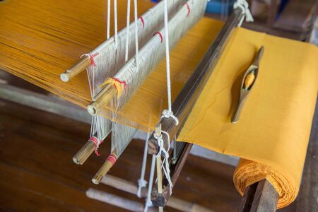 silk production atthe Wood Temple of Wat Jom Sawan in the old Town the city centre of Phrae in the north of Thailand.  Thailand, Phrae November, 2018.のeditorial素材