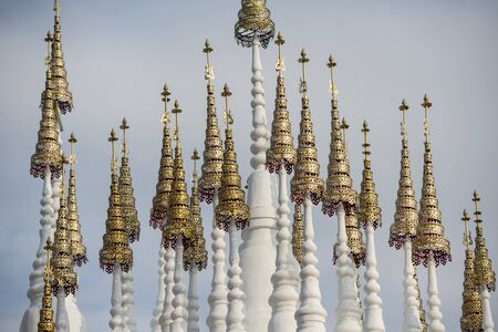 the white and golden Stupas and chedi at a rood of a temple at Wat Pong Sunan Temple in the city of  Phrae in the north of Thailand.  Thailand, Phrae November, 2018.のeditorial素材