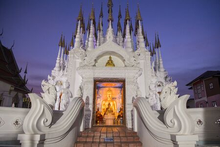 a buddha statue at Wat Pong Sunan Temple at dusk the city of  Phrae in the north of Thailand.  Thailand, Phrae November, 2018.のeditorial素材
