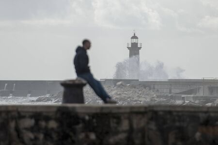 the Lighttower by wind and storm at the beachfront on the coast in the city centre of Porto in Porugal in Europe. Portugal, Porto, April, 2019のeditorial素材