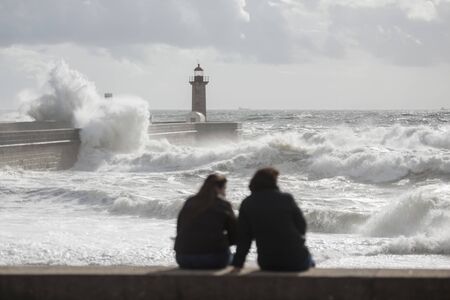 the Lighttower by wind and storm at the beachfront on the coast in the city centre of Porto in Porugal in Europe. Portugal, Porto, April, 2019のeditorial素材
