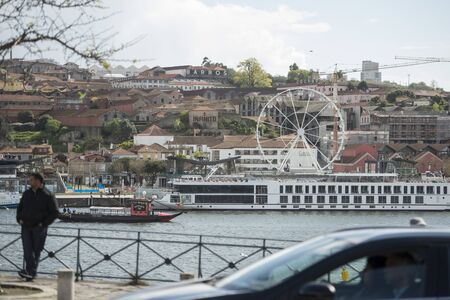 a ferris wheel at the waterfront on the Douro River in Ribeira in the city centre of Porto in Porugal in Europe.  Portugal, Porto, April, 2019のeditorial素材