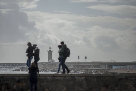 the Lighttower by wind and storm at the beachfront on the coast in the city centre of Porto in Porugal in Europe. Portugal, Porto, April, 2019のeditorial素材