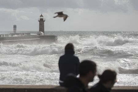 the Lighttower by wind and storm at the beachfront on the coast in the city centre of Porto in Porugal in Europe. Portugal, Porto, April, 2019のeditorial素材