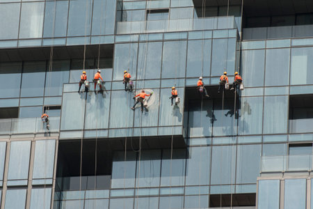 a team of high-rise builging cleaner at work at the Maha Nakhon Building in Silom in the city of...